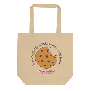 This is a tan tote bag with a giant chocolate chip cookie in the center. It has the quote "Because One Good Cookie Makes the World A Little Sweeter" around the cookie and Momma Holland's logo at the bottom. 